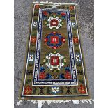 Contemporary Chinese superwash green ground rug, with three circular foliate medallions with key-