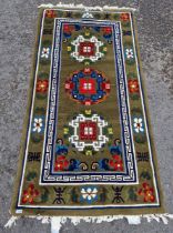 Contemporary Chinese superwash green ground rug, with three circular foliate medallions with key-