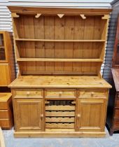 Antique pine kitchen dresser, the top section comprising two fitted shelves raised over three