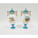 Pair of Minton bone china turquoise ground two-handled oviform vases with domed covers, circa