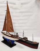 Mid-20th century pond yacht, with a blue painted hull, sails and rigging, on ebonised stand, 63cm