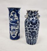 Two Chinese Qing dynasty blue and white vases, the first of sleeve form painted with precious