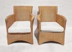 Pair of 20th century Lloyd Loom wicker armchairs each with removable seat cushion, 82cm high approx.
