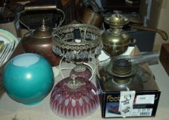 Brass paraffin lamp with a green glass globe, a brass paraffin lamp with chimney and a modern