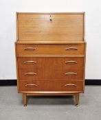 Mid-century teak bureau by Jentique, the bureau having a fall front top section above four