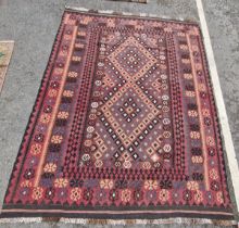 Afghan kilim, woven with central lozenge-shaped double medallion in black, blue and deep purple