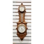 Early 20th century oak-cased aneroid barometer/thermometer with carved foliate motifs throughout the