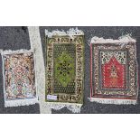 Three Middle Eastern silk small prayer rugs, the first woven with a vase of flowers flanked by deer,