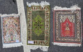 Three Middle Eastern silk small prayer rugs, the first woven with a vase of flowers flanked by deer,