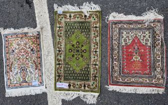 Three Middle Eastern silk small prayer rugs, the first woven with a vase of flowers flanked by deer,