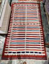 Persian kilim rug, woven with stripes in red, blue, manganese and green, on a cream ground and