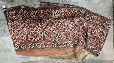 Caucasian rug bag or cover, woven with lozenge-shaped pattern borders on a pink ground, 97cm x 50cm