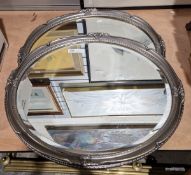 Pair of modern oval mirrors within a gesso silvered frame, bevelled edges, 56cm x 65cm (2)