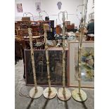 Two pairs of pale green onyx standard lamps on circular bases and turned columns