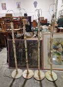 Two pairs of pale green onyx standard lamps on circular bases and turned columns