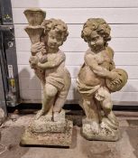 Two reconstituted garden figures in the form of cupid, one holding a torch, the other cymbals,