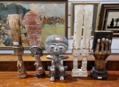 Various African carved deities/fertility gods and a carved ornament showing a hand holding a book (