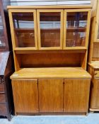 Mid-century teak sideboard, the top section having three glazed cupboards, each with a single