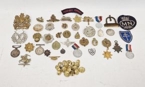 Collection of military gilt buttons, badges and a helmet plate and other items including a George