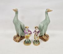 Pair of Chinese Export Kangxi-style celadon glazed models of ducks, on shaped mottled brown bases,