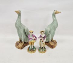 Pair of Chinese Export Kangxi-style celadon glazed models of ducks, on shaped mottled brown bases,