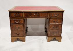 Late 19th/early 20th century mahogany twin pedestal desk with gilt tooled red leather inset top,