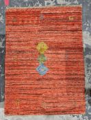 Peruvian style red ground rug with brown stripes decorated with three central coloured lozenges