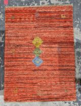 Peruvian style red ground rug with brown stripes decorated with three central coloured lozenges