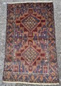 Baluchi rug woven with foliate lozenge medallions in grey, brown, green and deep red, within