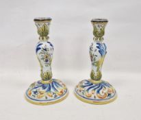 Pair of French faience baluster candlesticks, late 19th/early 20th century, painted with