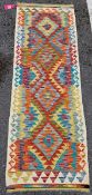 Chobi kilim runner, woven with bold geometric lozenges in orange, red, blue and yellow, within