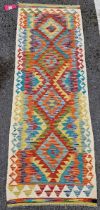 Chobi kilim runner, woven with bold geometric lozenges in orange, red, blue and yellow, within