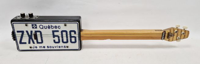 Novelty numberplate box guitar, the numberplate inscribed 'Quebec ZXD 506 Je me Souviens', 85cm long