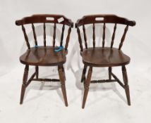 A pair of twentieth century captain's/smoker's chairs with turned spindle backs, measuring approx 77