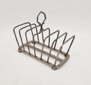 George V silver six division toast rack by Hukin & Heath, rectangular form raised on bun feet,