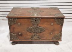 Antique stained hardwood Indonesian coffer, adorned with embossed brass plaques and rivets, the