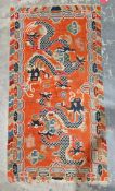 Pair of Chinese style rugs, possibly Tibetan, the central panel with two dragons chasing flaming