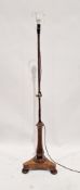 Victorian stained wooden telescopic standard lamp raised on tripod base, on bun feet, 145cm high