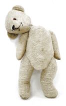 Early 20th century blonde Teddy bear with glass eyes, stitched nose and mouth over a humped back