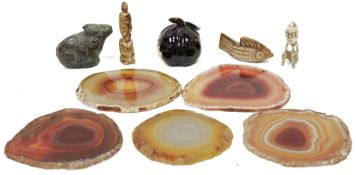 Five polished slices of agate, two small carvings of tribal figures, probably bone, a carved and