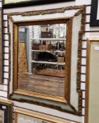 Late 19th/early 20th century gilt framed wall mirror with scroll decoration, the central bevelled