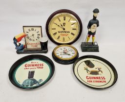 Collection of Guinness related items including a circular tray, three clocks, including a ceramic