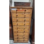 Large quantity of Meccano in tall narrow pine chest of nine short drawers, having turned wood knob