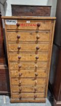 Large quantity of Meccano in tall narrow pine chest of nine short drawers, having turned wood knob