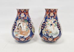 Pair of Japanese early 20th century Imari baluster vases, each decorated with panels of birds and