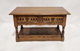 A twentieth century oak coffee table of rectangular form with two short drawers to the front each