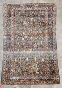 Silk Teheran rug, the shaded grey-green field with garden design of stylised multi-coloured large
