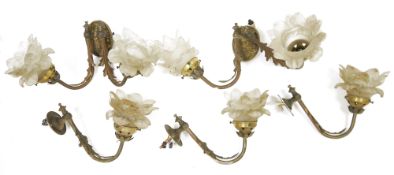 Group of gilt-metal and opaque glass wall lights, each with frosted glass petal-shaped sconces