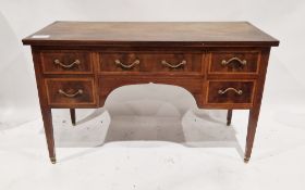 Early 20th century mahogany veneer desk having a central long drawer flanked on either side by two