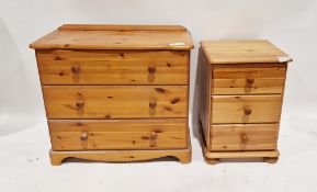 A modern pine chest of drawers having three long drawers each with turned wooden handles,